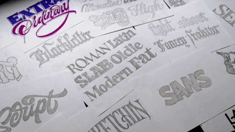 Variety of unique typography sketches on paper.