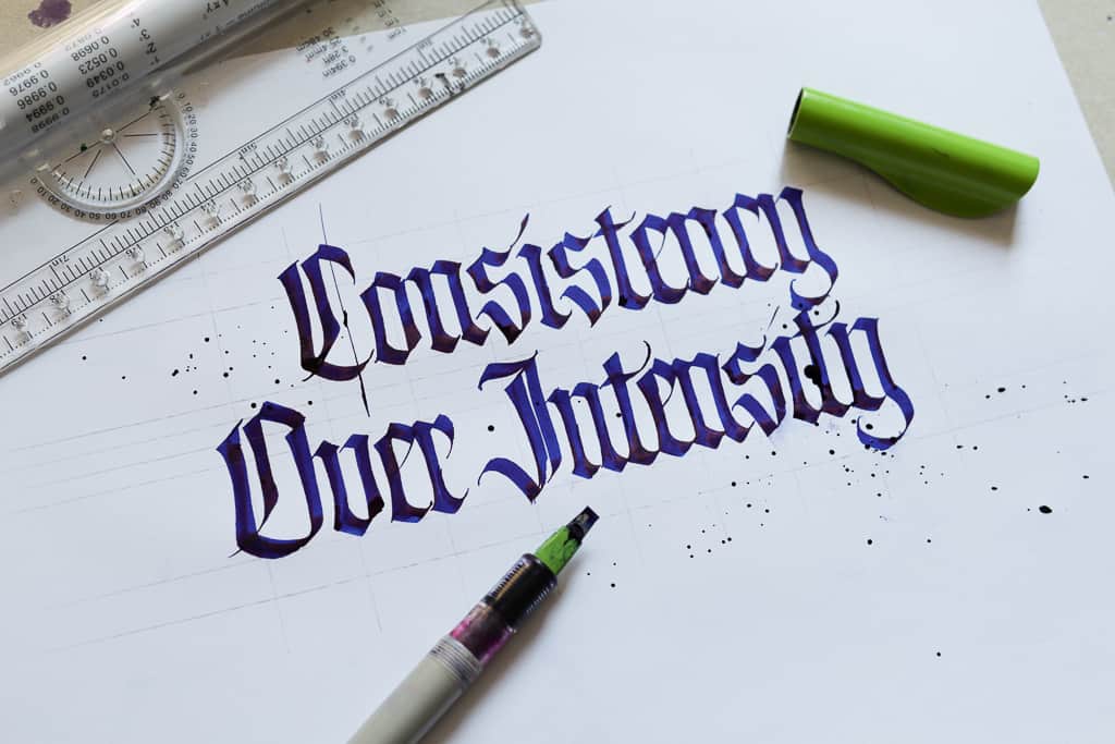 Consistency Over Intensity written in blackletter calligraphy with a Pilot Parallel Pen. 