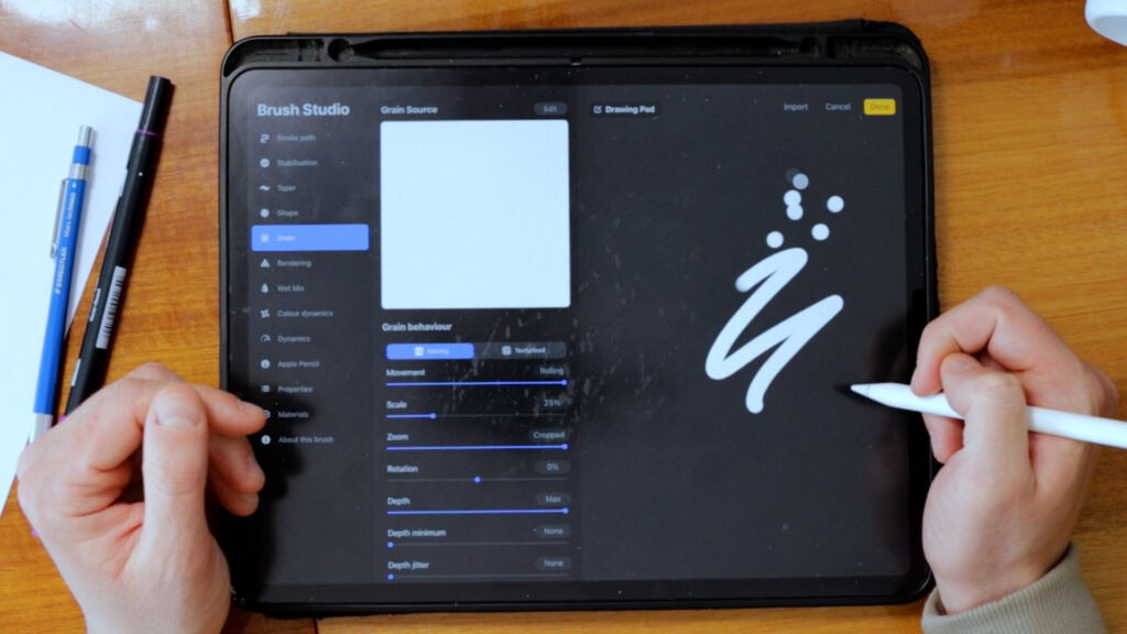 Hand using digital drawing app on tablet