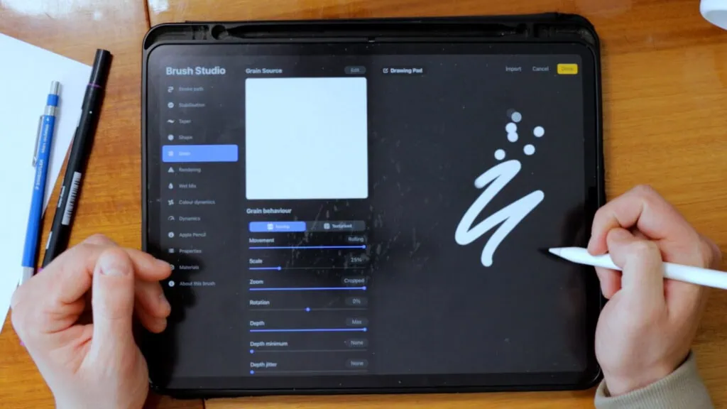 Hand using digital drawing app on tablet