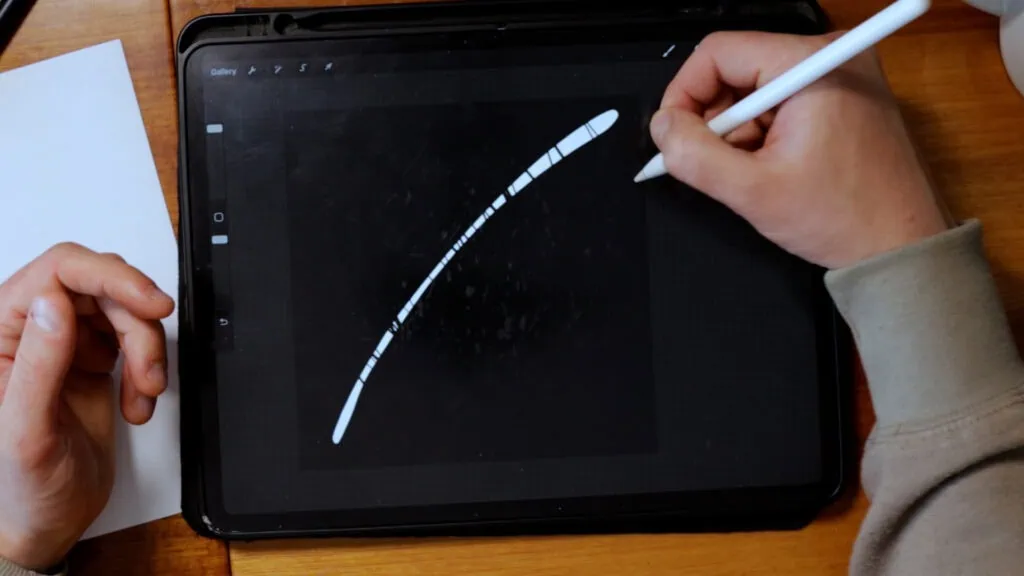 Person drawing on a tablet with stylus