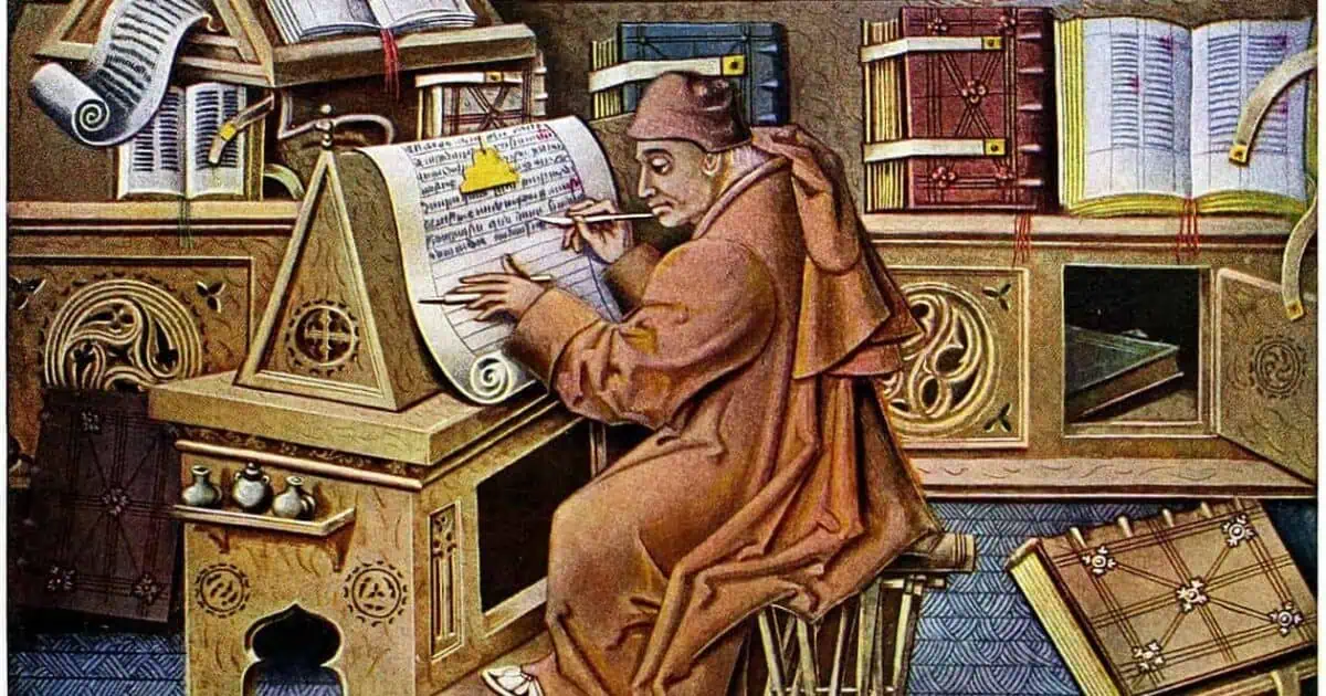Monk writing at a medieval desk surrounded by books.