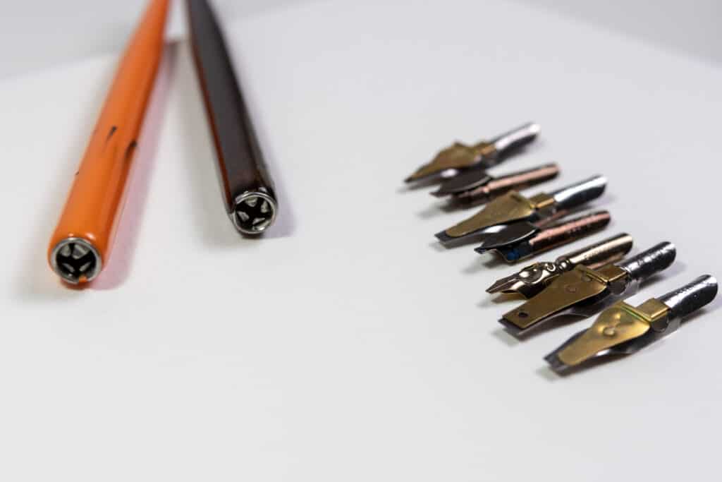 Straight nib holders and broad-edged nibs in various sizes.