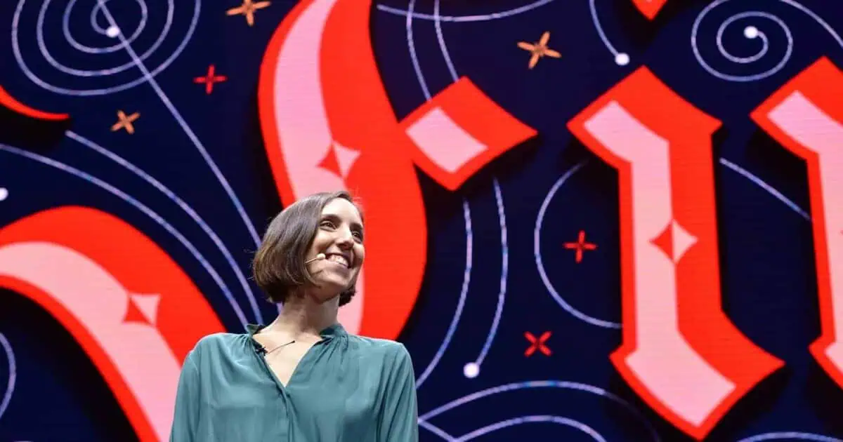 Smiling speaker in front of colorful backdrop