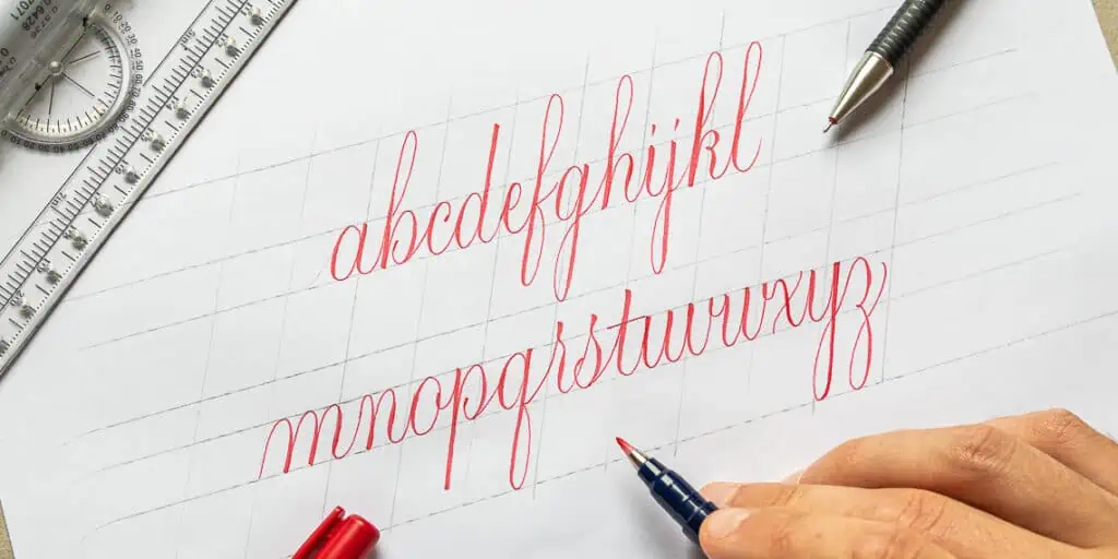 Practice of cursive handwriting with red ink.