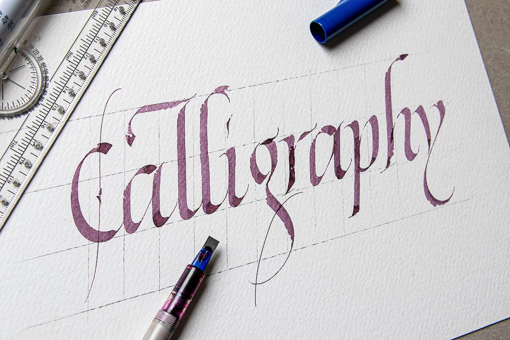 italic calligraphy sample on watercolor paper. 