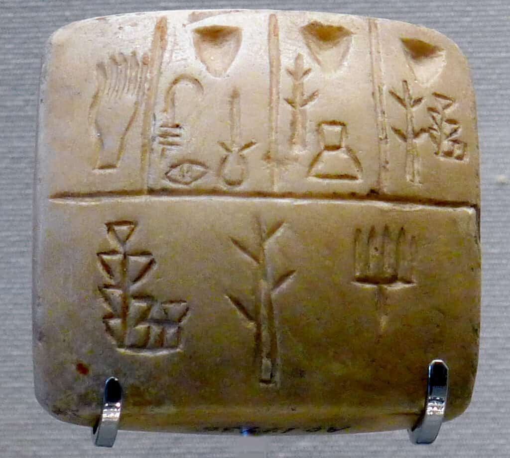Tablet with proto-cuneiform pictographic characters (end of 4th millennium BC), Uruk III. This is thought to be a list of slaves' names, the hand in the upper left corner representing the owner.[24]