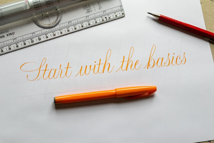 orange brush calligraphy with a brush pen on white paper.