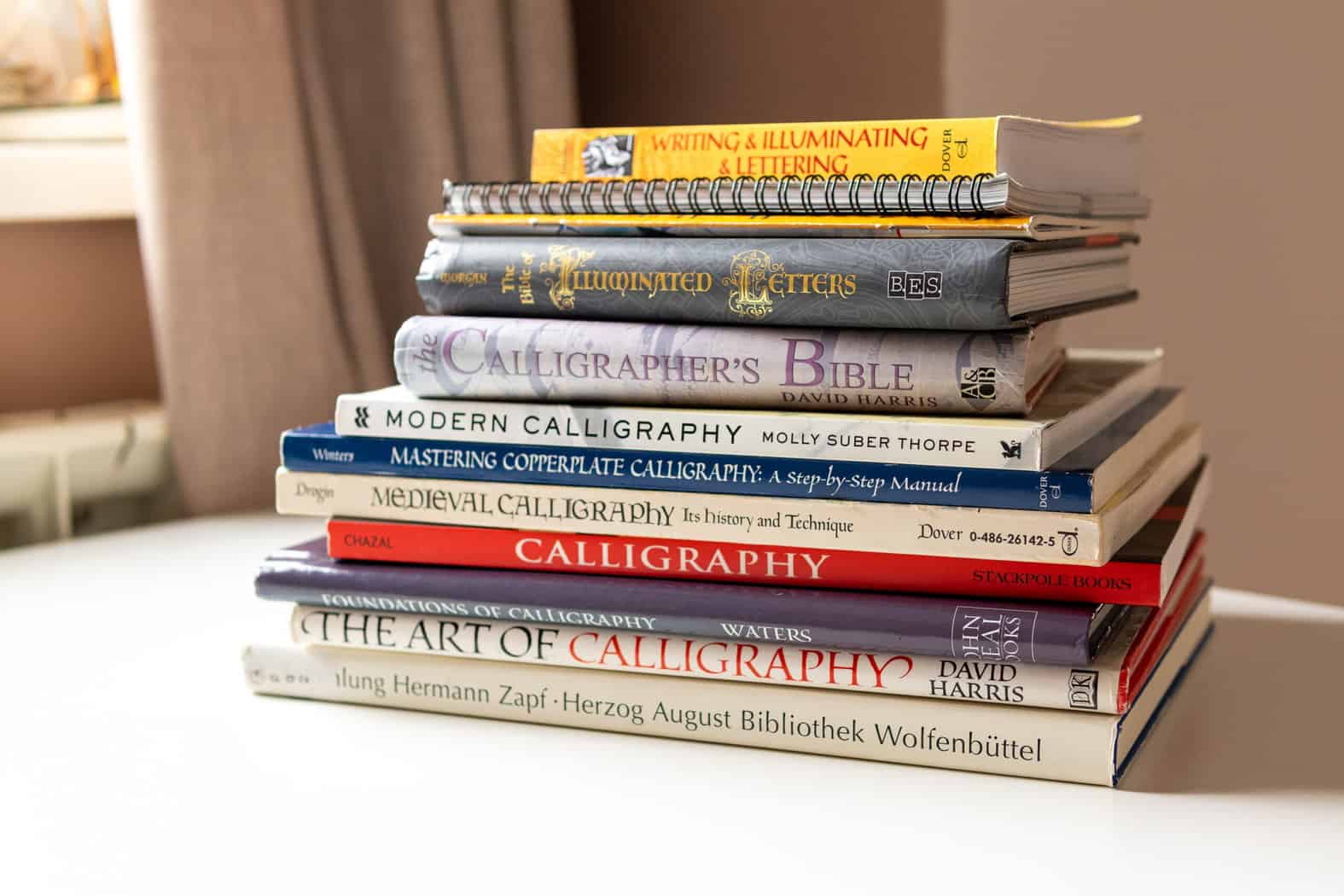 Stack of calligraphy and lettering books