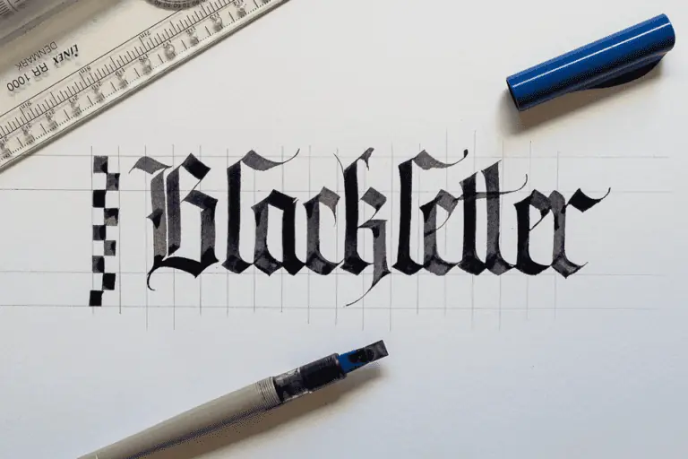 Blackletter calligraphy in progress with tools