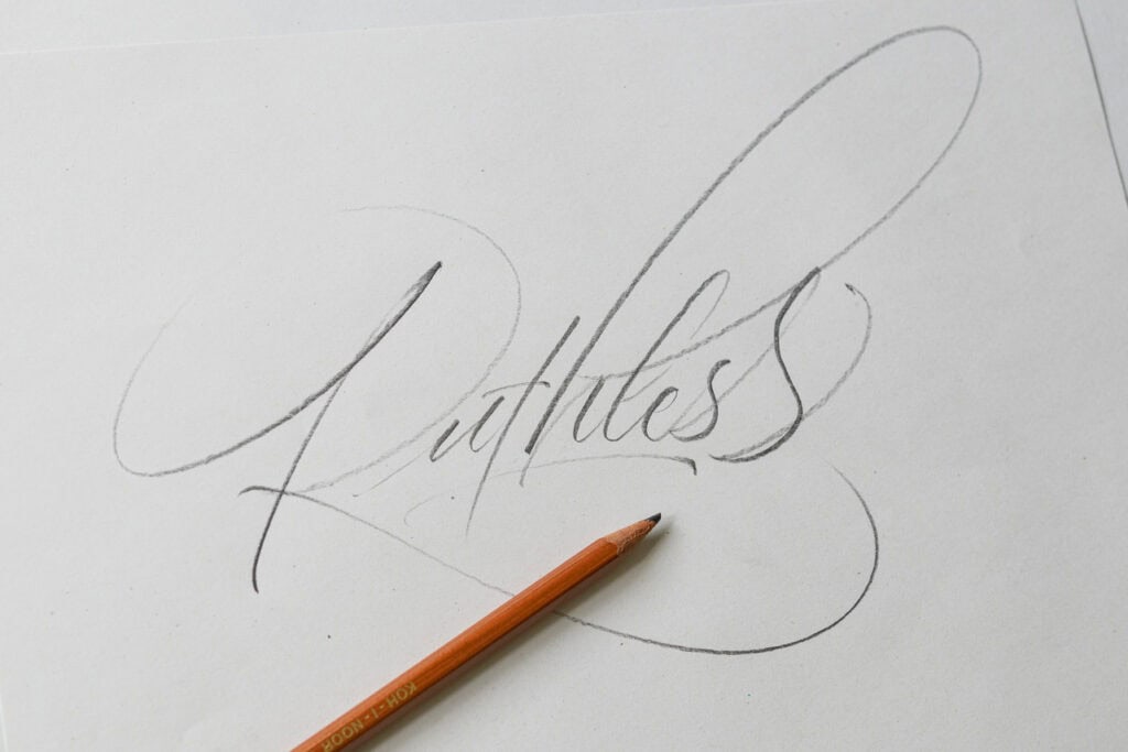 Handwritten word 'Ruthless' in pencil on paper