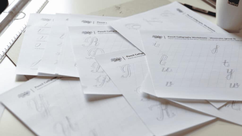 Calligraphy practice worksheets on a table.