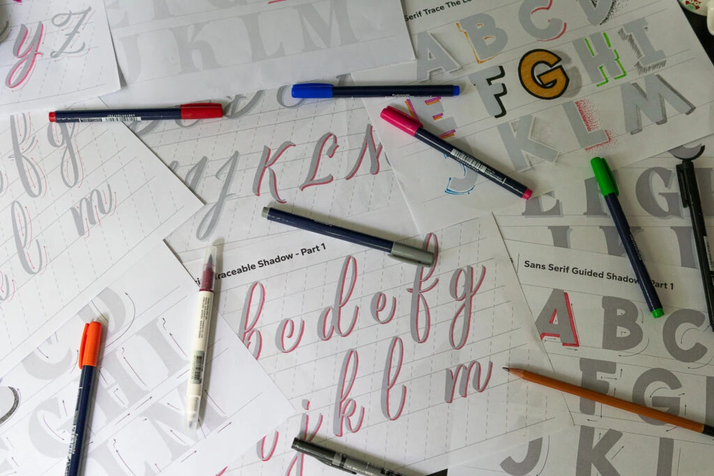 Scattered tracing sheets with colorful pens.