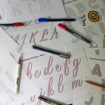 Scattered tracing sheets with colorful pens.