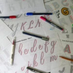 Scattered tracing sheets with colorful pens.