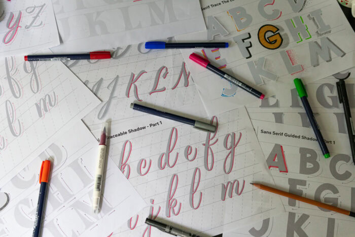 Scattered tracing sheets with colorful pens.