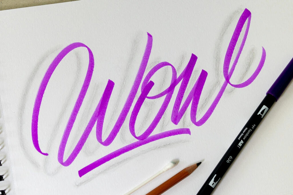 Handwritten 'Wow' in vibrant purple color