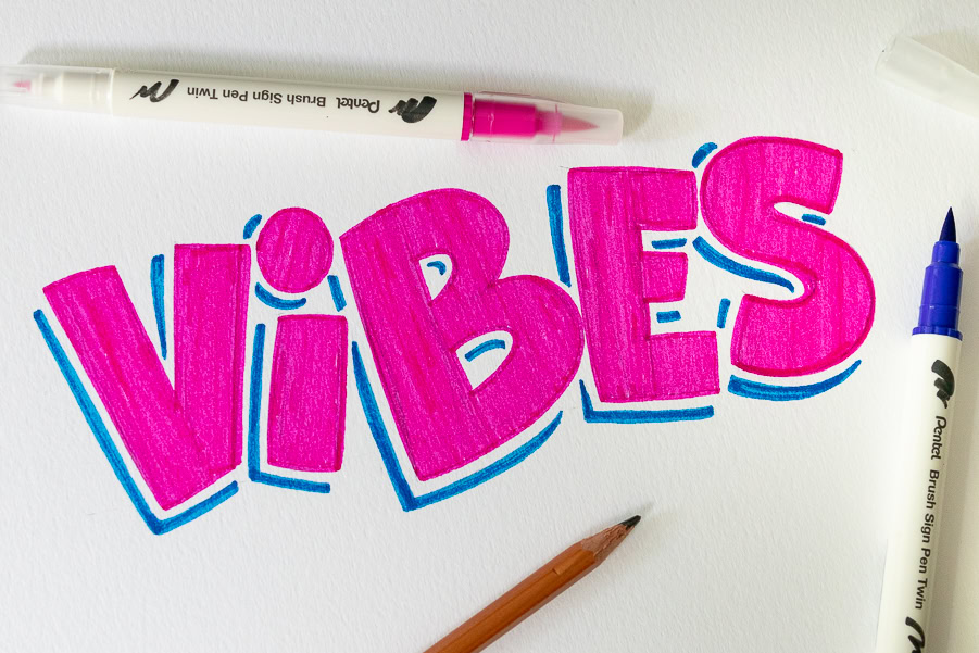 Colorful 'Vibes' lettering with art supplies
