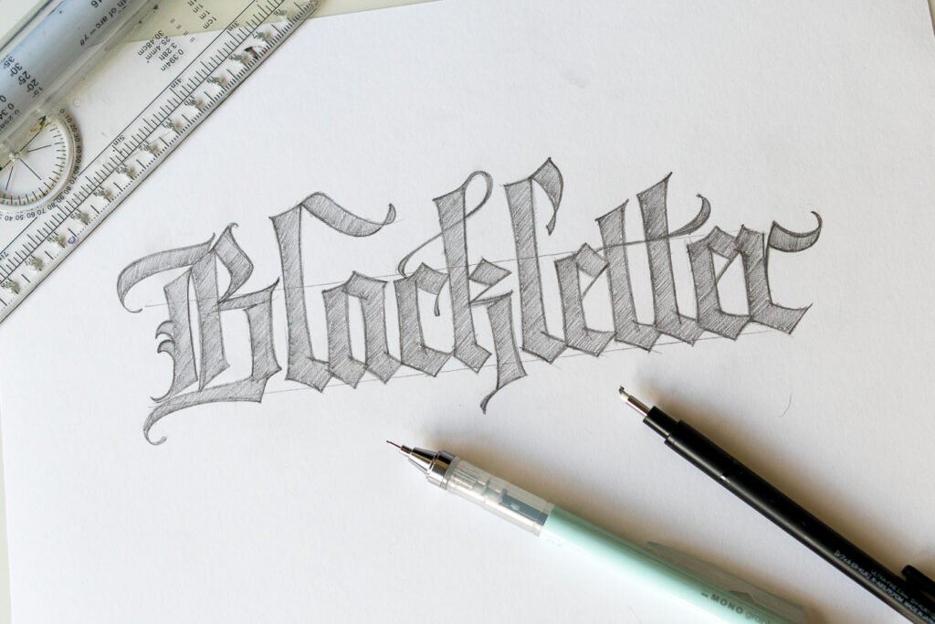 Sketch of 'Blackletter' calligraphy on paper.