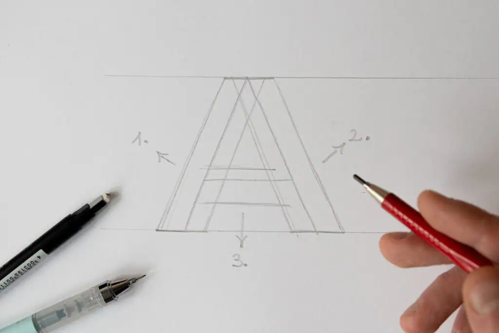 Hand sketching a geometric drawing step-by-step
