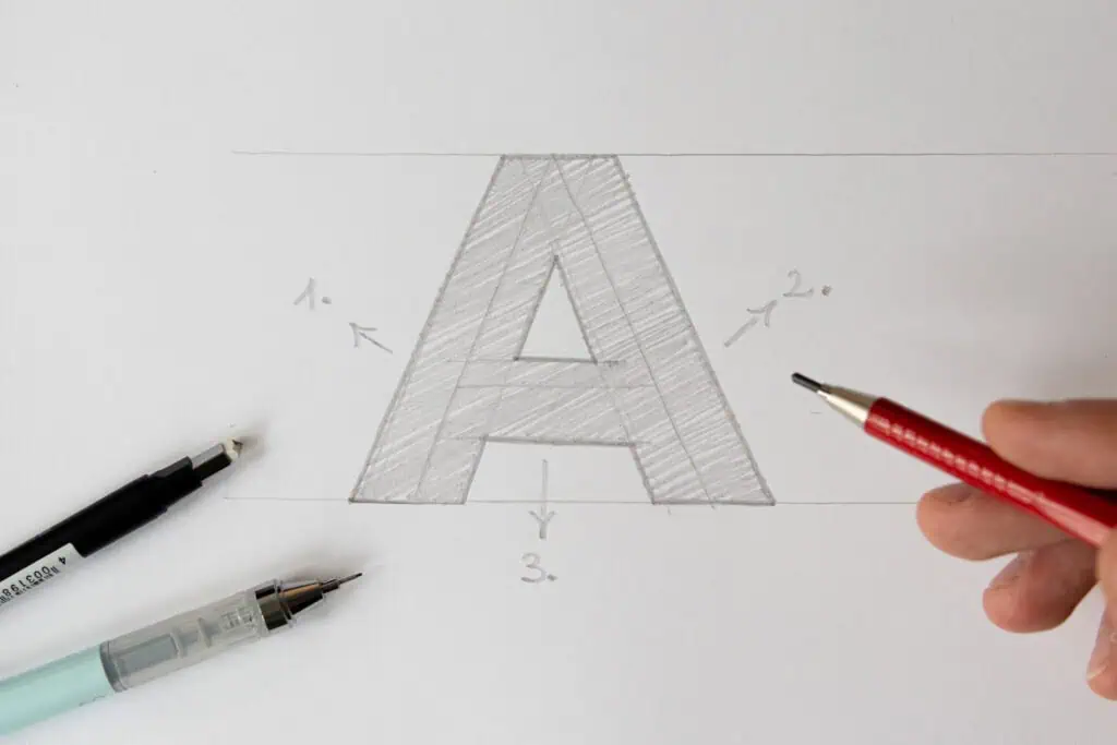 Drawing the letter 'A' with various pens.