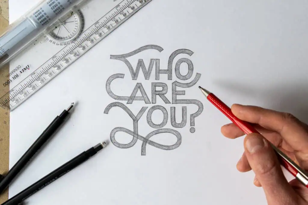 Hand drawing text 'Who Care You?' on paper